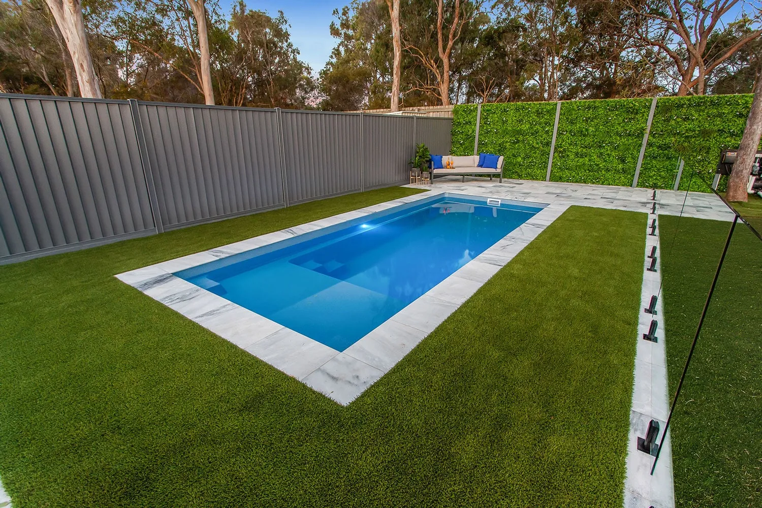 Latham Enchantment 9.17 compact pool in a narrow landscaped backyard